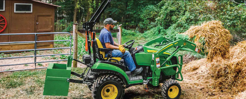 Image of man riding tractor