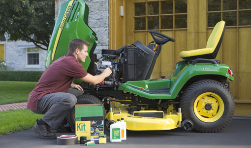 Image of man working on riding mower