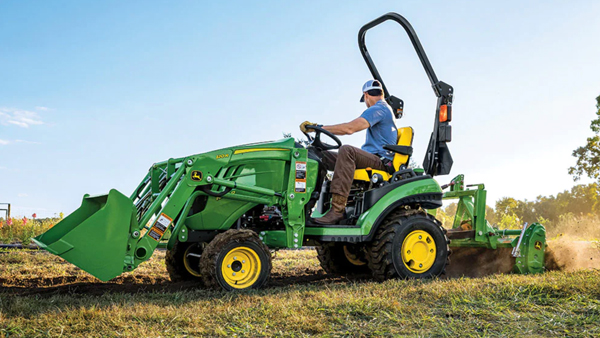 Image of man driving small tractor