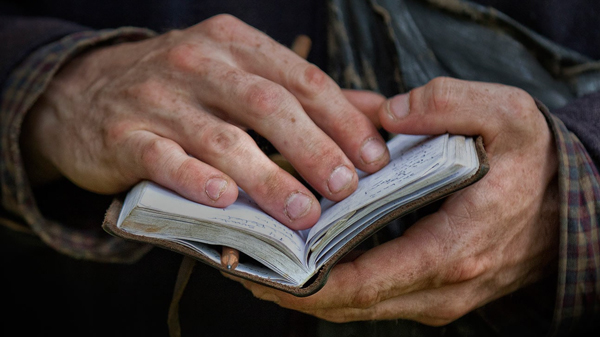 Image of hands holding notebook