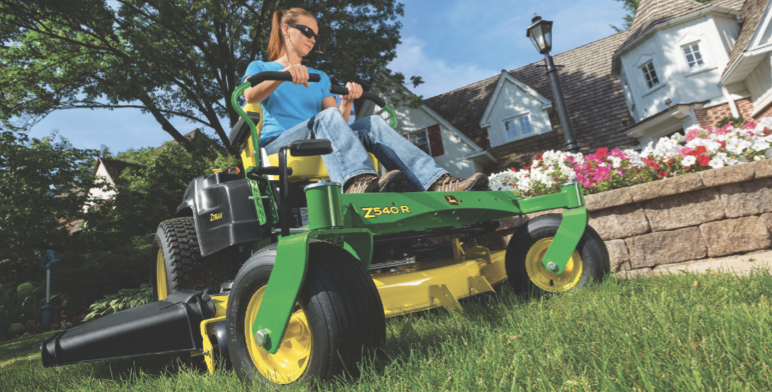 image of woman riding zero-turn mower
