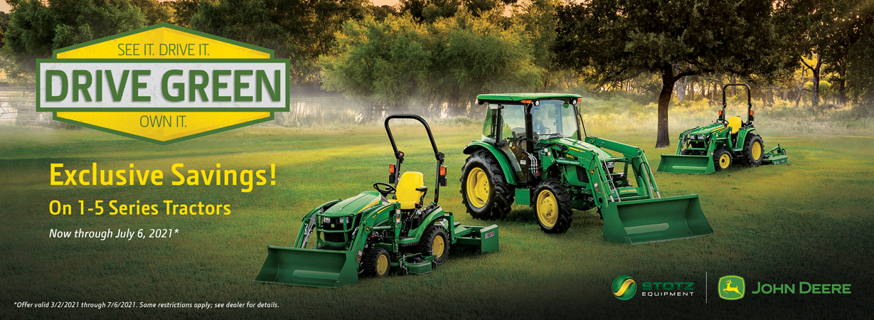 Image of three John Deere Tractors on misty lawn.