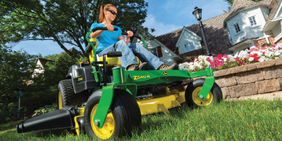 Image of woman riding a z-track mower