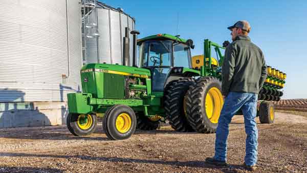 Image of man in front of tractor